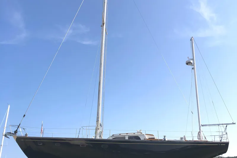Slide: The Image of 1972 Fastnet Le Comte sailboat with tall mast against clear blue sky. - 1