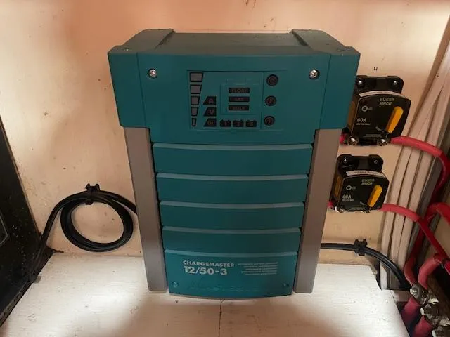 Slide: The Image of Battery charger setup on 1972 Fastnet Le Comte boat, featuring ChargeMaster 12/50-3. - 12