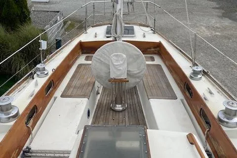 Slide: The Image of 1972 Fastnet Le Comte sailboat deck with wooden trim and steering wheel cover. - 6