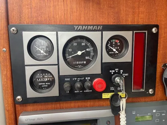 Slide: The Image of Yanmar engine control panel on 1972 Fastnet Le Comte boat, featuring gauges and switches. - 8