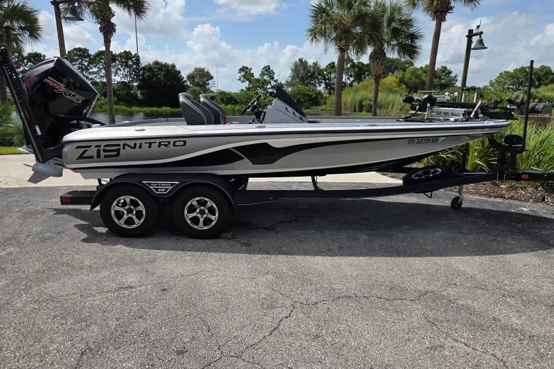Slide: The Image of 2023 Nitro Z19 Pro boat on trailer, parked outdoors with palm trees in background. - 1
