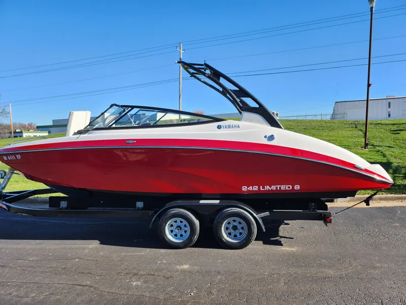 Slide: The Image of 2016 Yamaha Boats 242 Limited S in red on trailer, side view. - 4