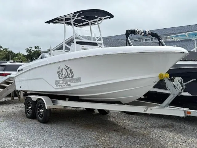 The Image of 2025 Wellcraft 202 Fisherman boat on trailer, white hull, parked outdoors. - 0