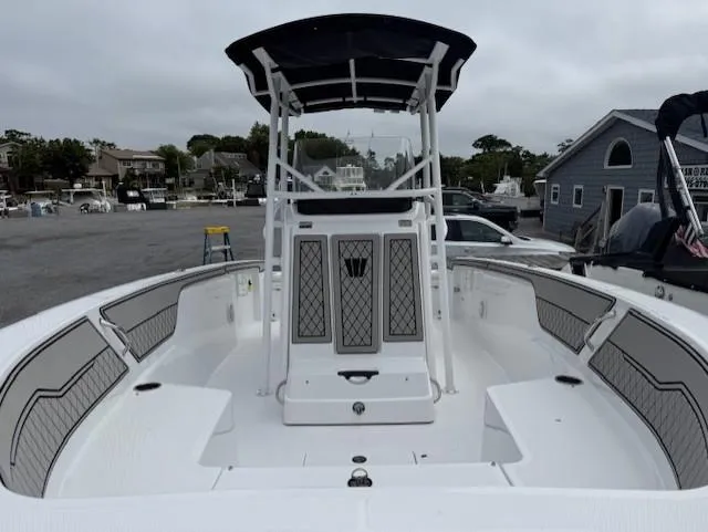 Slide: The Image of 2025 Wellcraft 202 Fisherman boat with spacious deck and modern design in a marina setting. - 11