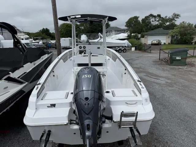 Slide: The Image of 2025 Wellcraft 202 Fisherman boat with 150 HP engine, parked in a marina. - 12