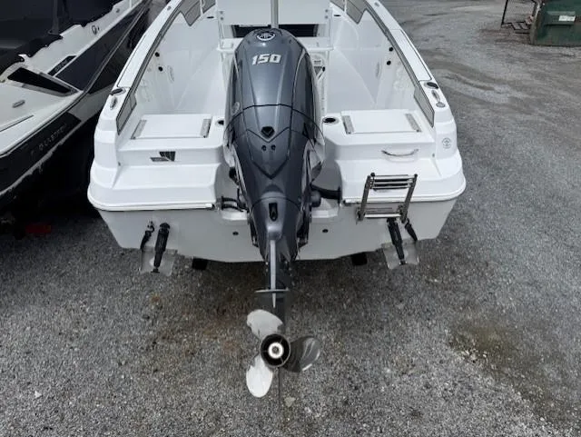 Slide: The Image of 2025 Wellcraft 202 Fisherman boat with 150 HP outboard motor, rear view. - 13