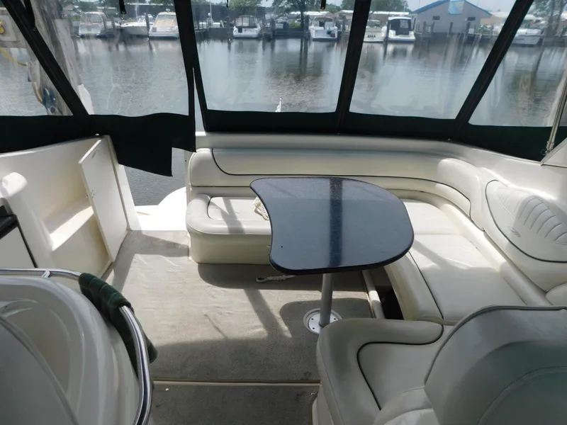 Slide: The Image of Interior of 2003 Maxum 3500 SY yacht with seating and table, docked at marina. - 10