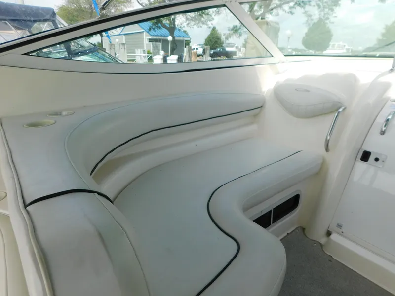 Slide: The Image of 2003 Maxum 3500 SY boat interior with white cushioned seating. - 11