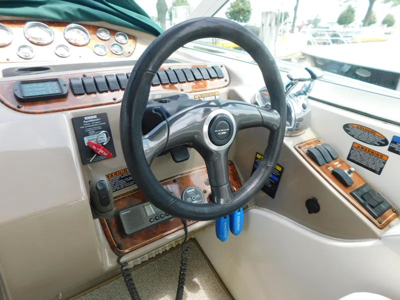 Slide: The Image of 2003 Maxum 3500 SY boat dashboard with steering wheel and control panel. - 15