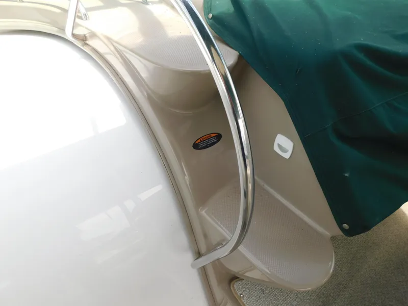Slide: The Image of Staircase on a 2003 Maxum 3500 SY boat with green cover and metal railing. - 18