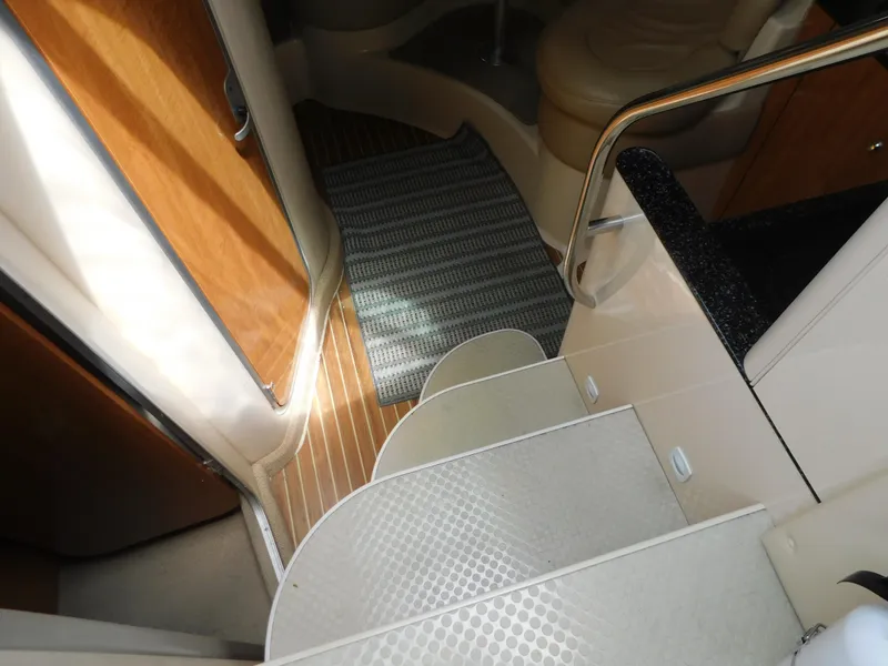 Slide: The Image of Interior stairs of 2003 Maxum 3500 SY yacht with wooden and carpeted flooring. - 19