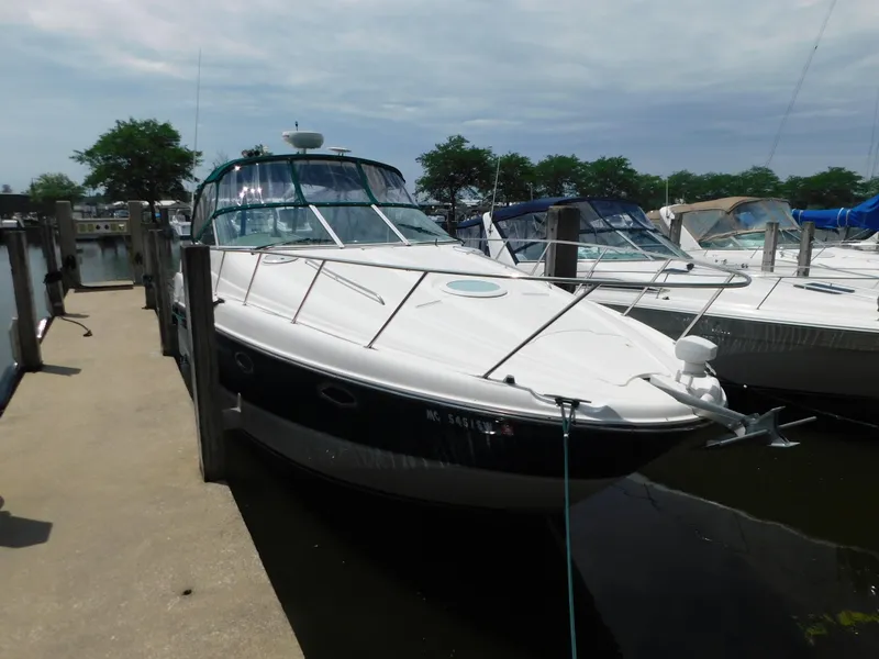 Slide: The Image of 2003 Maxum 3500 SY yacht docked at marina under cloudy sky. - 2