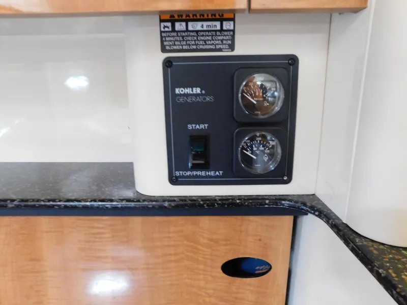 Slide: The Image of Control panel of a 2003 Maxum 3500 SY boat with Kohler generator controls. - 33