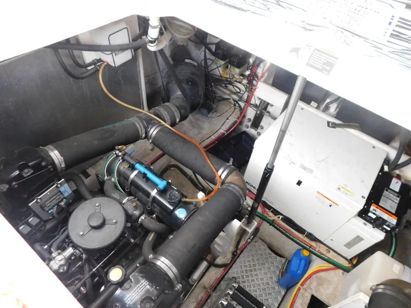 Slide: The Image of Engine compartment of a 2003 Maxum 3500 SY boat, showcasing mechanical components. - 34