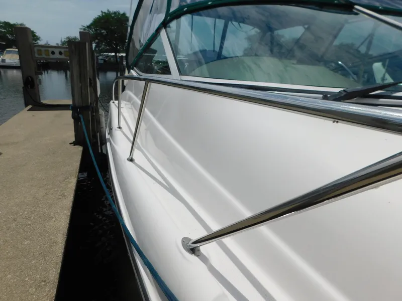 Slide: The Image of 2003 Maxum 3500 SY yacht docked at marina, side view with railing. - 4