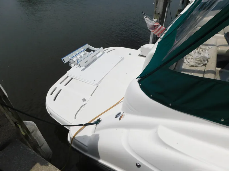 Slide: The Image of 2003 Maxum 3500 SY boat docked, featuring a white deck and green canopy. - 5