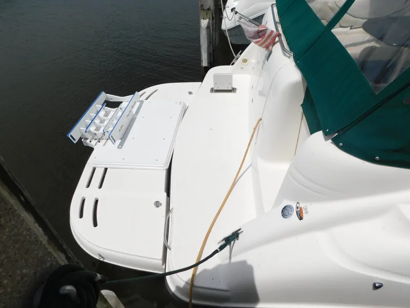 Slide: The Image of 2003 Maxum 3500 SY boat with green canopy docked at marina. - 6