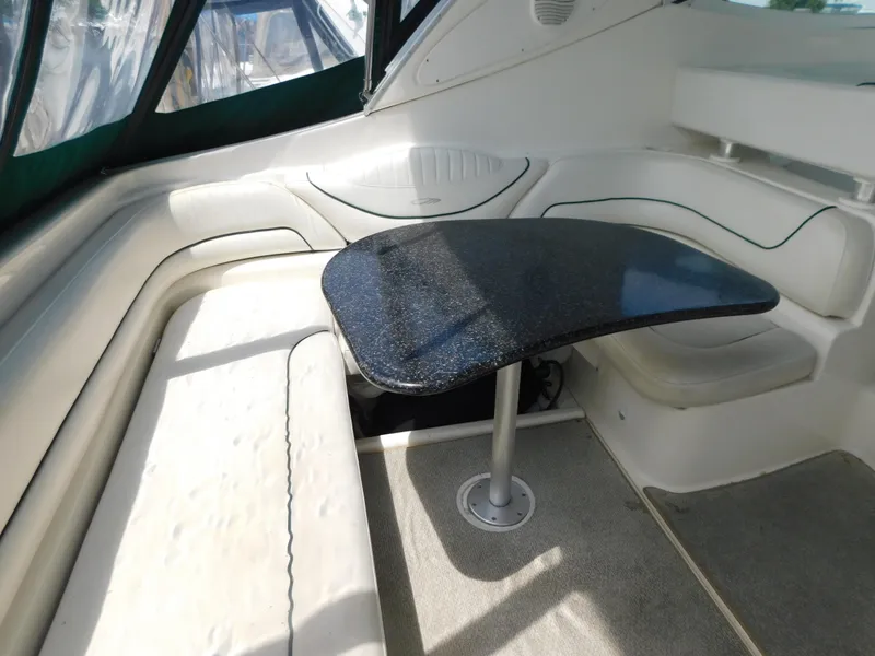 Slide: The Image of Interior seating area of 2003 Maxum 3500 SY yacht with a sleek black table. - 7