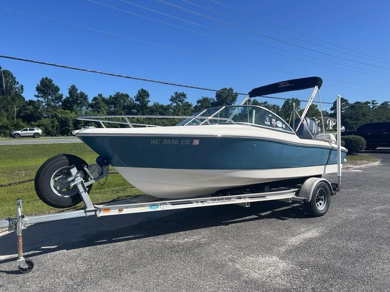 Slide: The Image of 2012 Pioneer 175 Venture boat on trailer, parked outdoors under clear blue sky. - 3