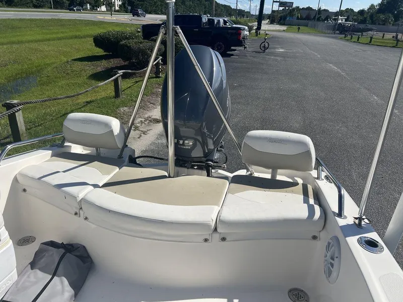 Slide: The Image of 2012 Pioneer 175 Venture boat with seating and outboard motor in a parking area. - 8