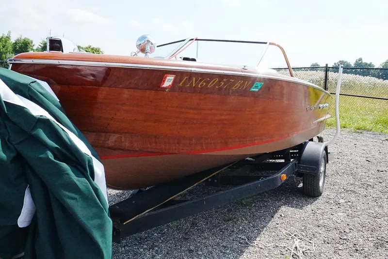 Slide: The Image of 1956 Chris-Craft Continental boat on trailer, showcasing classic wooden design. - 11