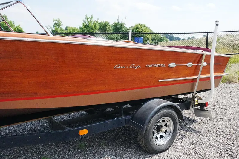 Slide: The Image of 1956 Chris-Craft Continental boat on trailer, showcasing classic wooden design. - 12