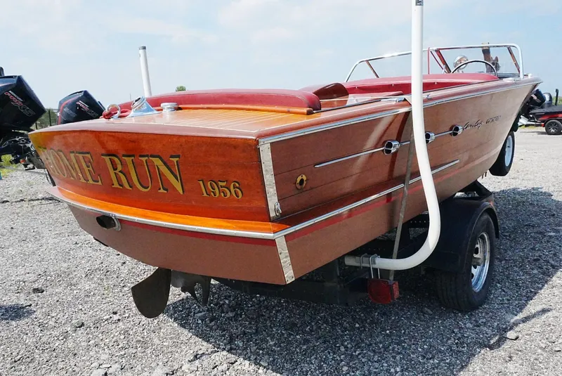Slide: The Image of 1956 Chris-Craft Continental boat on trailer, showcasing classic wooden design and "Home Run" lettering. - 14