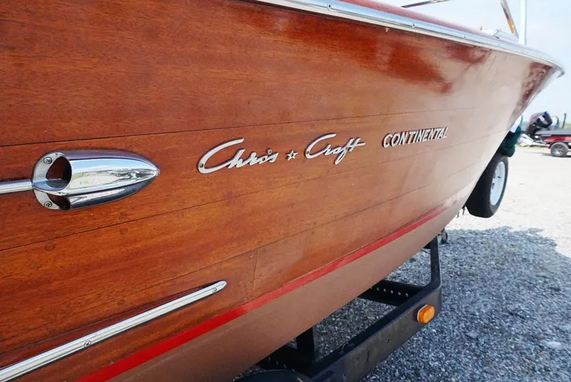 Slide: The Image of 1956 Chris-Craft Continental wooden boat with chrome details on display. - 17