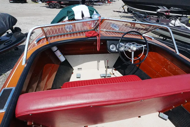 Slide: The Image of 1956 Chris-Craft Continental boat interior with red seating and classic steering wheel. - 3