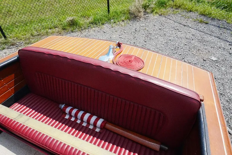 Slide: The Image of 1956 Chris-Craft Continental boat with red leather seating and wooden deck. - 6