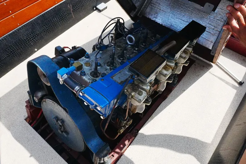 Slide: The Image of 1956 Chris-Craft Continental engine, blue and metallic components, partially open compartment. - 8