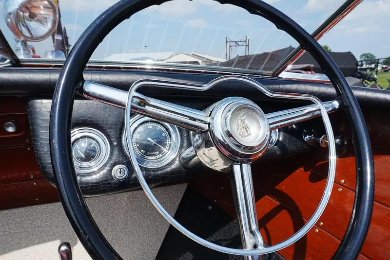 Slide: The Image of 1956 Chris-Craft Continental dashboard with classic steering wheel and vintage gauges. - 9