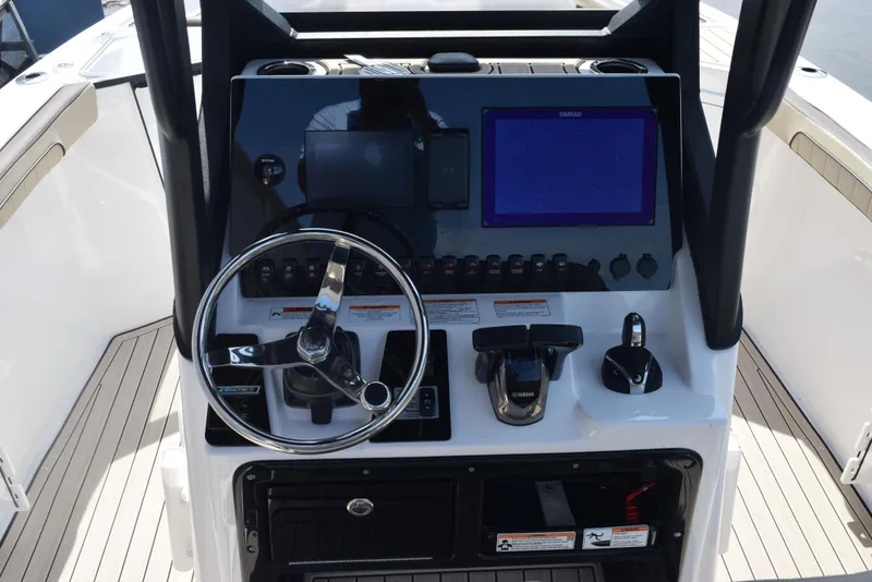 Slide: The Image of 2024 Yamaha Boats 255 FSH Sport H dashboard with steering wheel and control panel. - 10