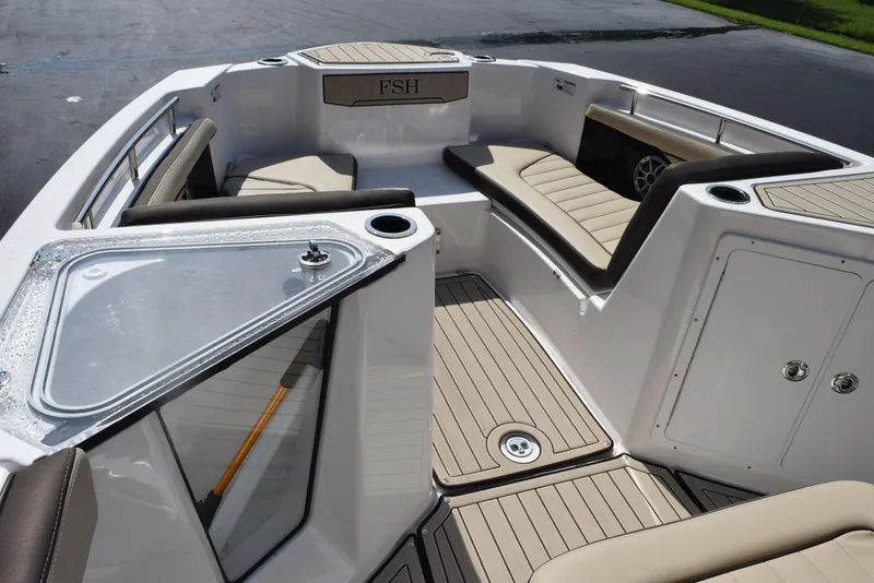 Slide: The Image of 2024 Yamaha Boats 255 FSH Sport H interior with seating and storage compartments. - 13