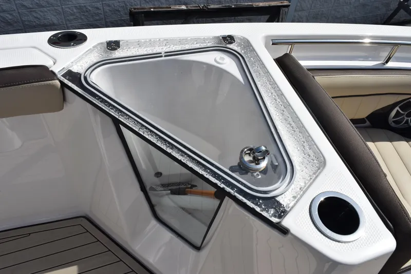 Slide: The Image of 2024 Yamaha Boats 255 FSH Sport H, featuring a sleek storage compartment with cup holders. - 17