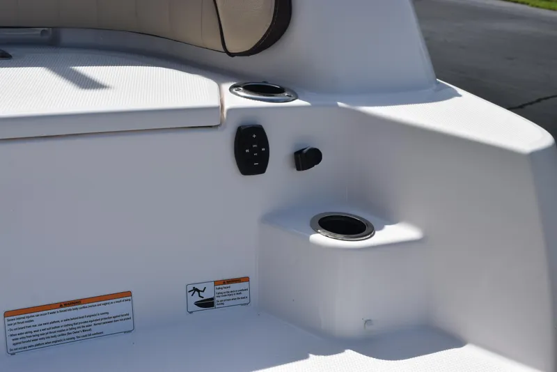 Slide: The Image of 2024 Yamaha Boats 255 FSH Sport H interior detail with cup holders and controls. - 7