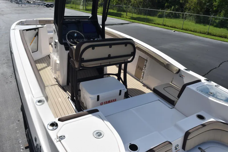 Slide: The Image of 2024 Yamaha Boats 255 FSH Sport H interior with seating and console. - 9