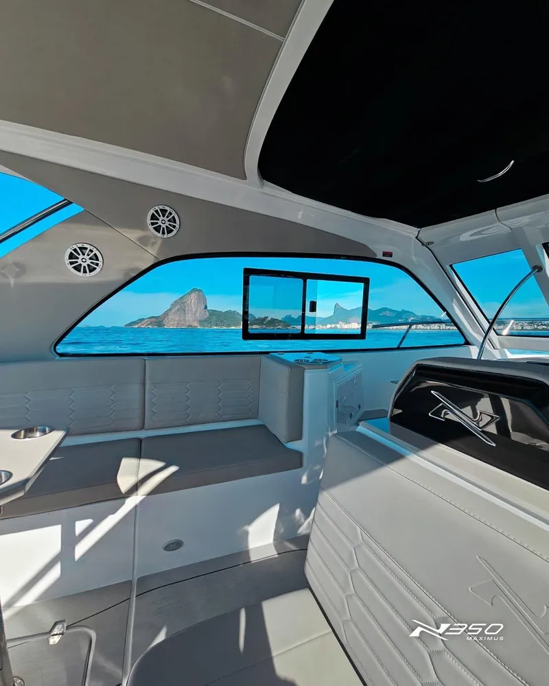 Slide: The Image of Interior of 2025 NX Boats NX350, featuring sleek design and ocean view through large windows. - 3