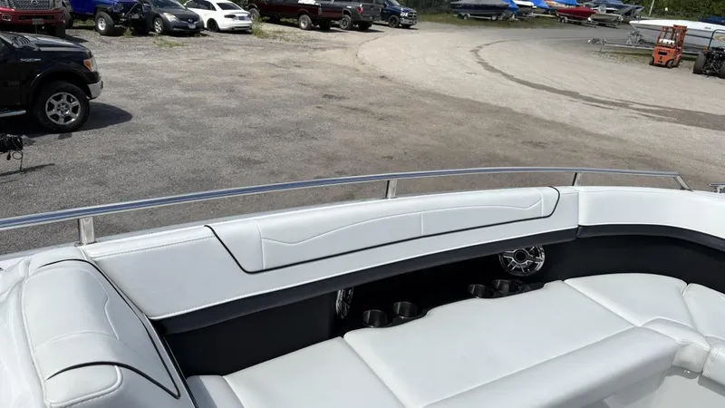 Slide: The Image of 2022 Formula 350 CBR boat with white seating and cup holders, parked in a lot. - 10