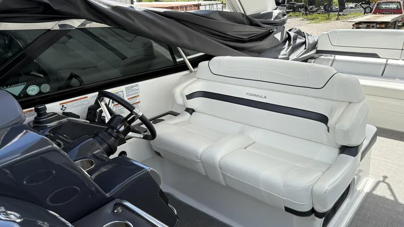 Slide: The Image of 2022 Formula 350 CBR boat interior with white seating and steering console. - 12