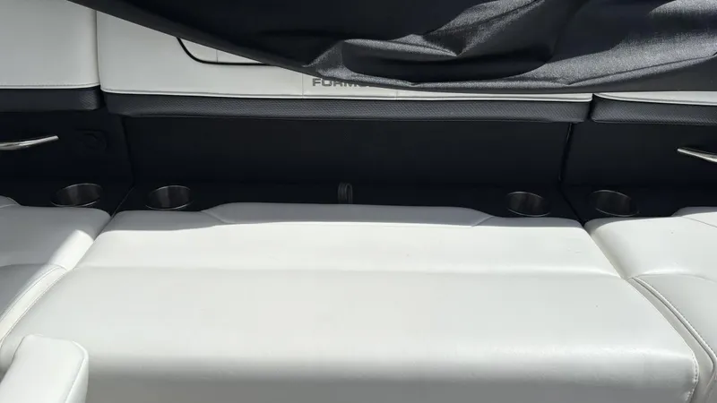 Slide: The Image of 2022 Formula 350 CBR boat interior with white seating and cup holders. - 16