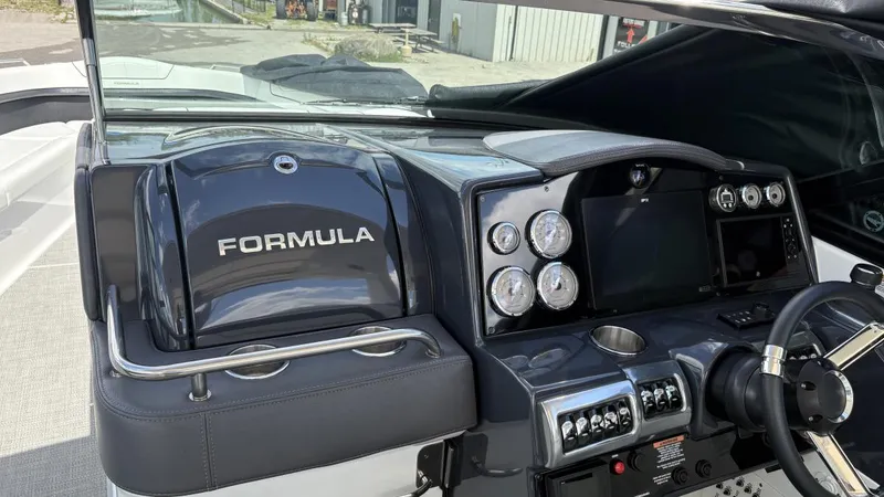 Slide: The Image of 2022 Formula 350 CBR boat dashboard with gauges, steering wheel, and control panel. - 19