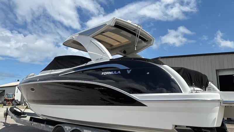 Slide: The Image of 2022 Formula 350 CBR boat on trailer under blue sky. - 2