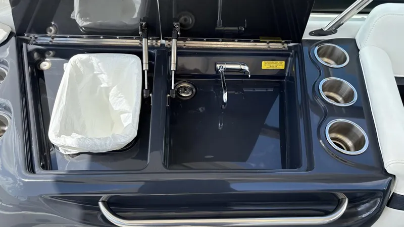 Slide: The Image of 2022 Formula 350 CBR boat sink and trash compartment with cup holders. - 25