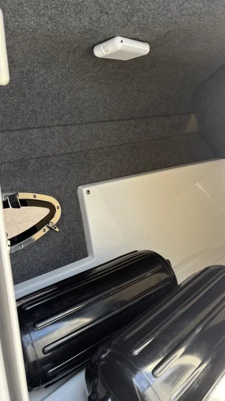 Slide: The Image of Interior view of a 2022 Formula 350 CBR boat, featuring storage compartments and black fenders. - 26