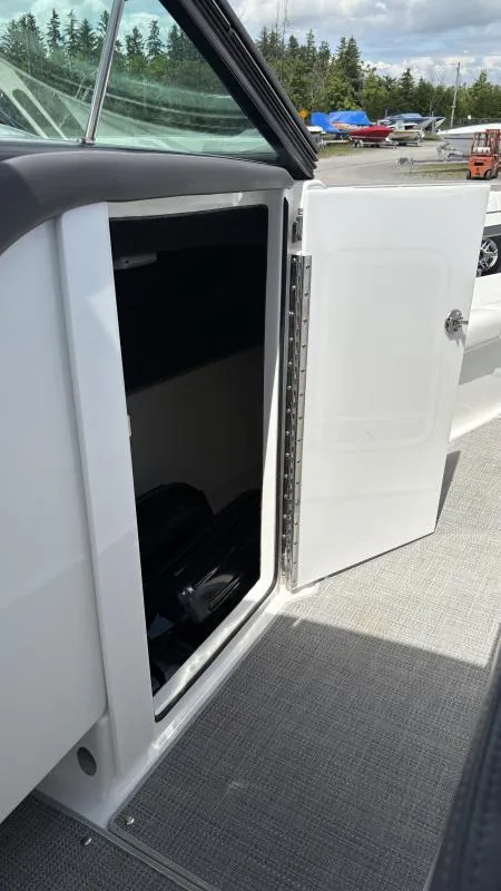Slide: The Image of 2022 Formula 350 CBR boat storage compartment with open door, showcasing interior space. - 27
