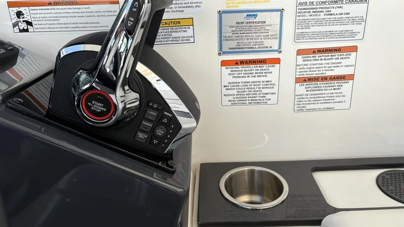 Slide: The Image of Control panel of 2022 Formula 350 CBR boat with warning labels and cup holder. - 29