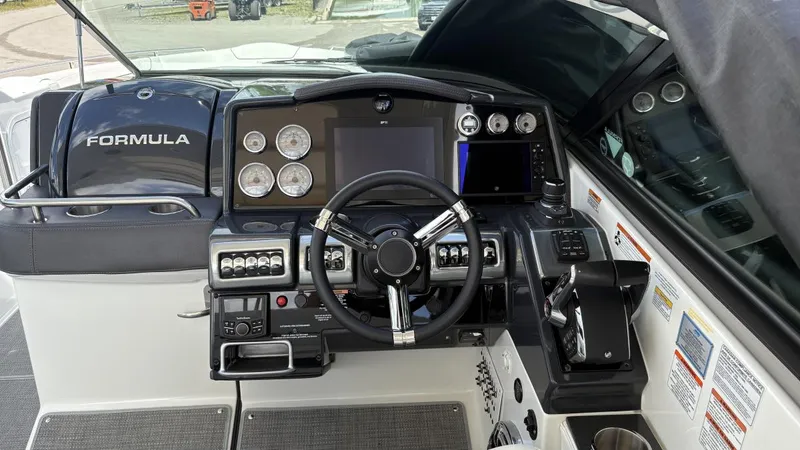 Slide: The Image of 2022 Formula 350 CBR boat dashboard with steering wheel and control panel. - 30