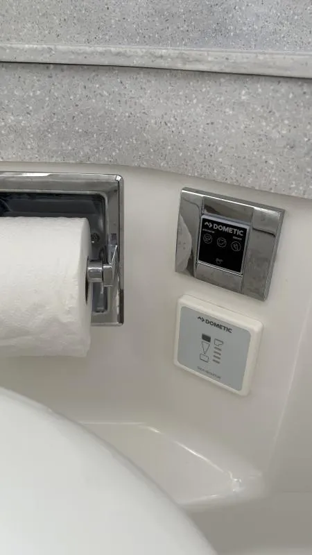 Slide: The Image of Toilet paper holder and Dometic control panel in 2022 Formula 350 CBR boat bathroom. - 32