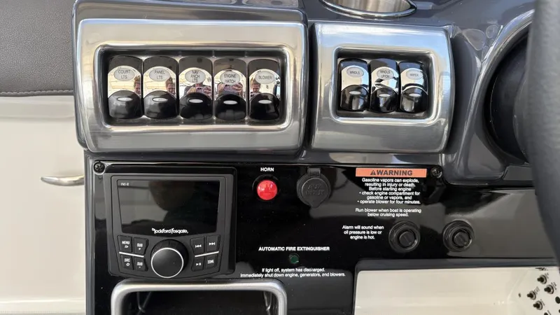 Slide: The Image of Control panel of a 2022 Formula 350 CBR boat with switches and audio system. - 33